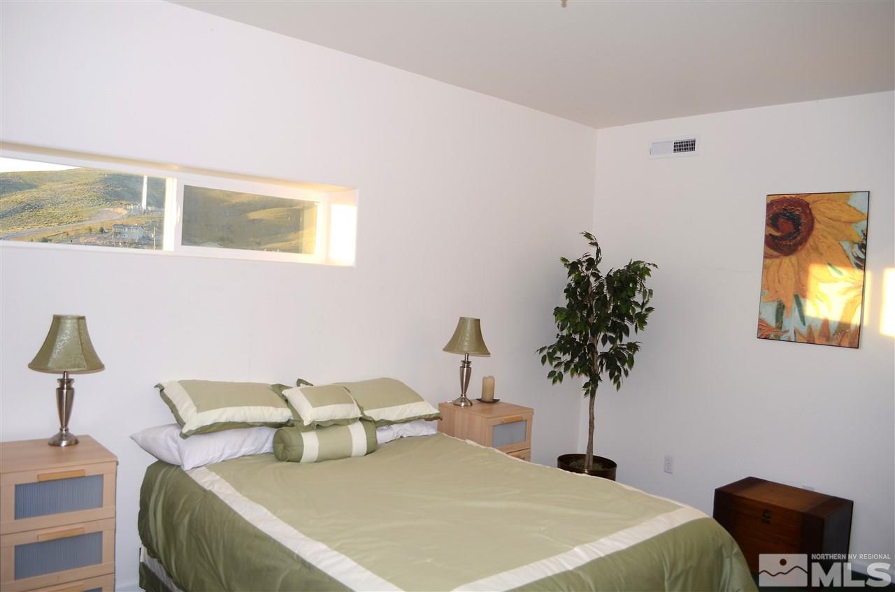 5100 Wayside Road Reno, NV 89510 - Photo 14 of 25 a bedroom with a bed and a potted plant