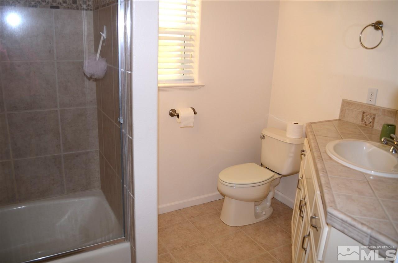 5100 Wayside Road Reno, NV 89510 - Photo 16 of 25 a bathroom with a toilet sink and shower