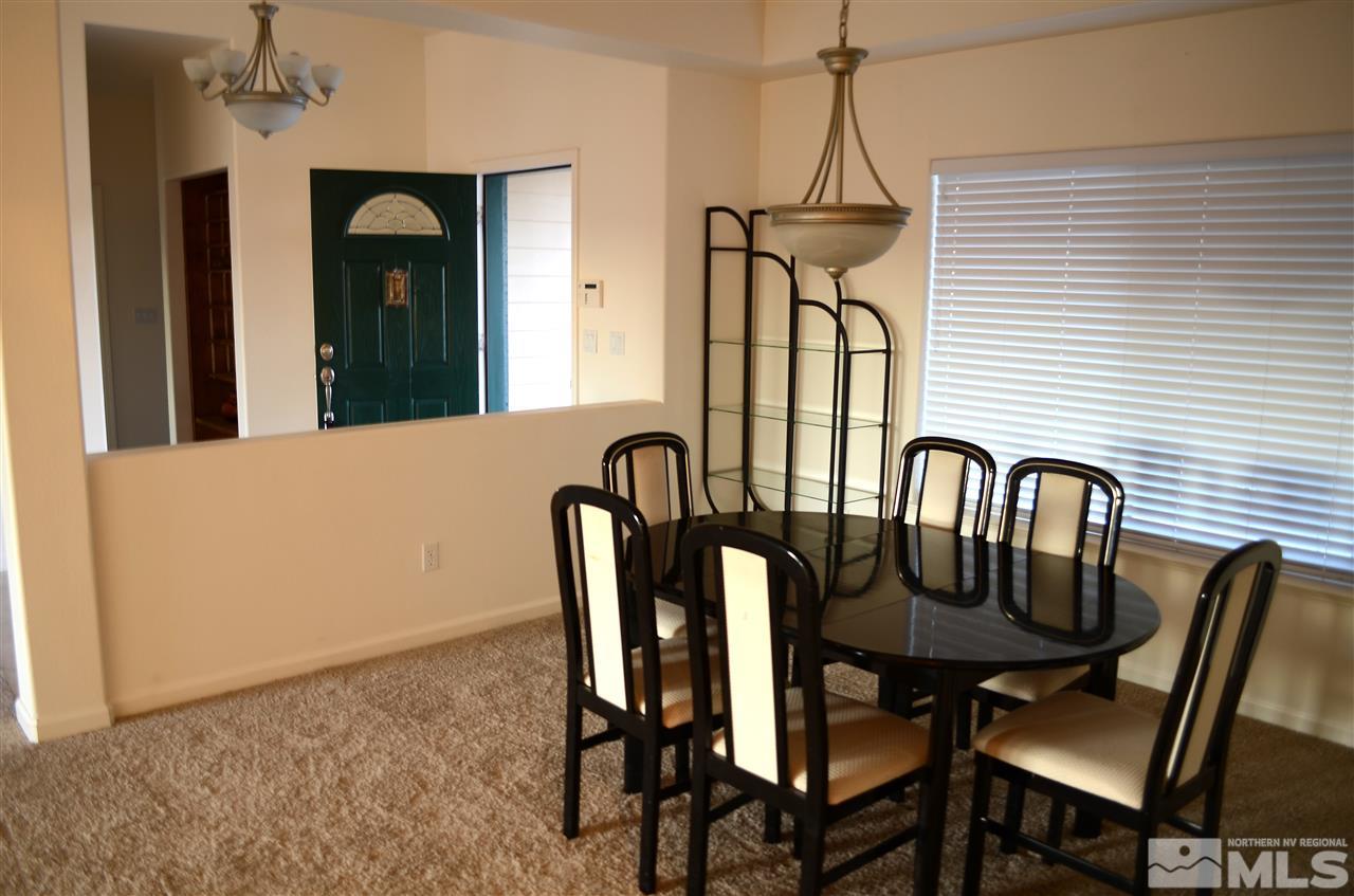 5100 Wayside Road Reno, NV 89510 - Photo 19 of 25 a view of a a dining room with furniture window and wooden floor