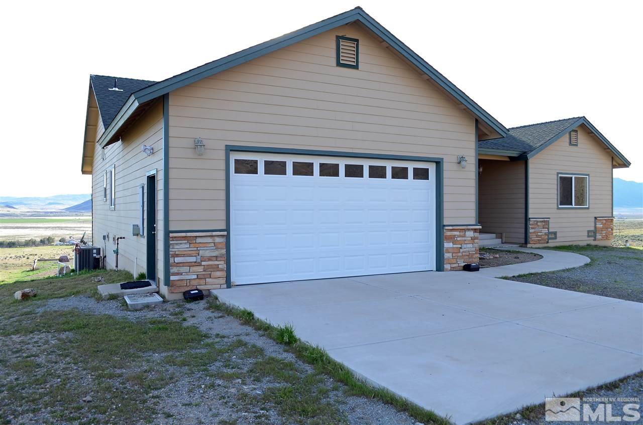 5100 Wayside Road Reno, NV 89510 - Photo 22 of 25 a front view of a house with a yard and garage