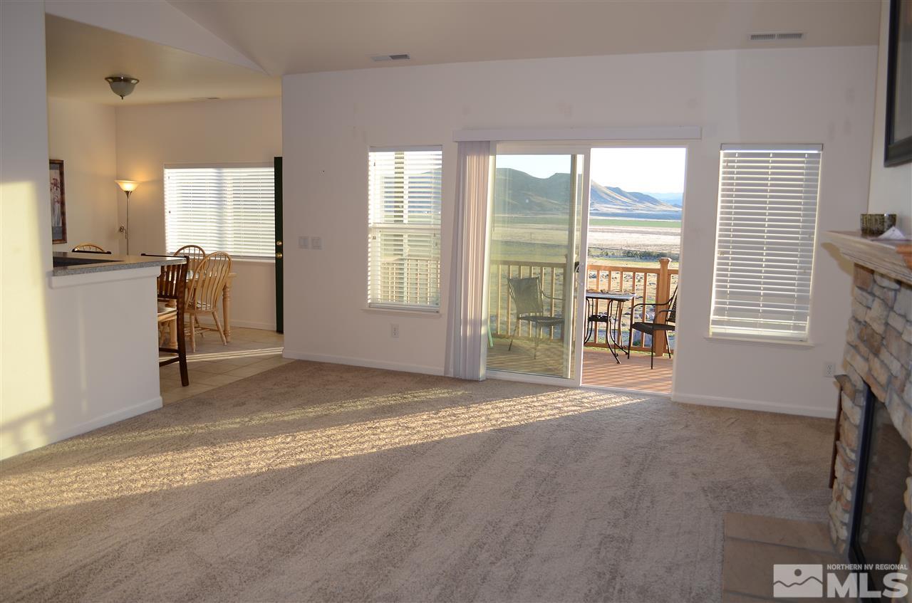 5100 Wayside Road Reno, NV 89510 - Photo 5 of 25 a view of an empty room with a fireplace and a window