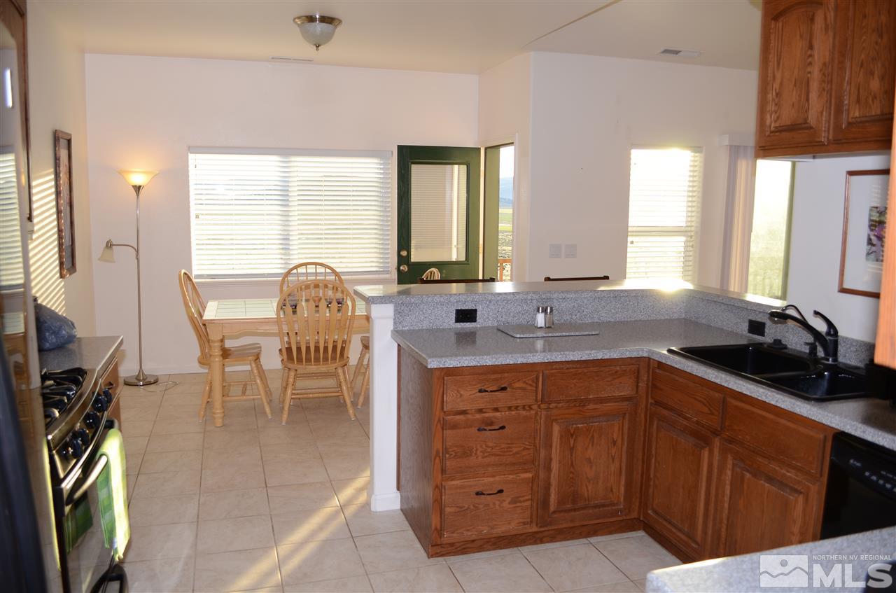 5100 Wayside Road Reno, NV 89510 - Photo 10 of 25 a view of a kitchen with granite countertop a sink stainless steel appliances cabinets and furniture