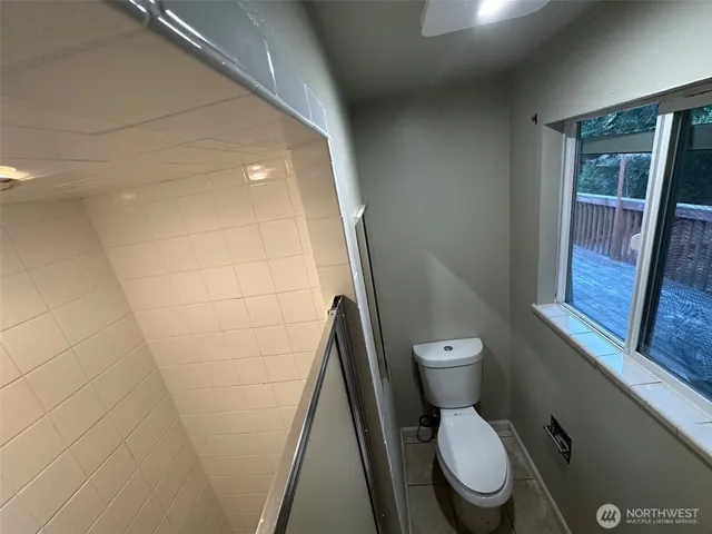 a white toilet sitting next to a small sink