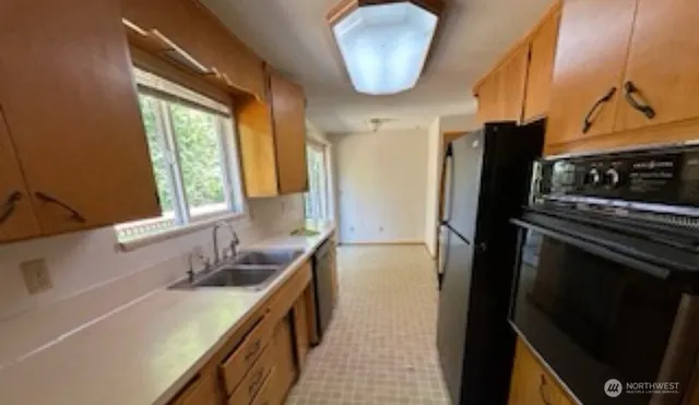 a kitchen with a refrigerator and a sink