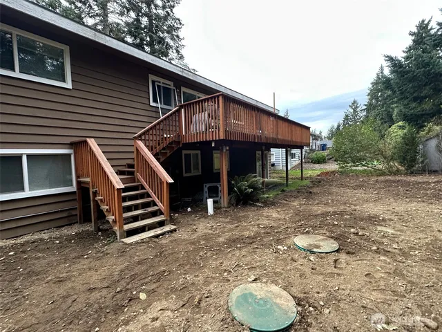 a backyard of a house with table and chairs
