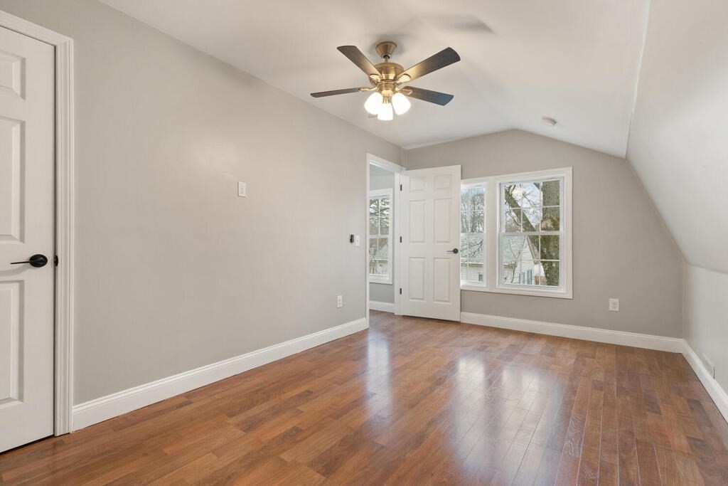 14 Middle Street Wakefield, MA 01880 - Photo 18 of 34 an empty room with wooden floor chandelier fan and windows