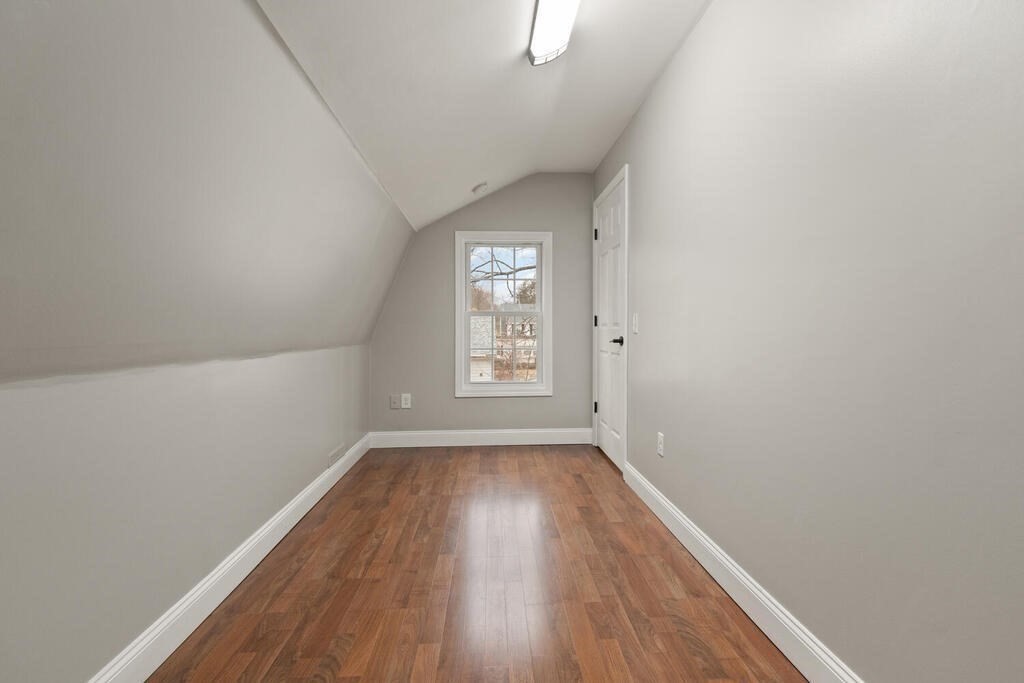 14 Middle Street Wakefield, MA 01880 - Photo 19 of 34 a view of an empty room with wooden floor and a window