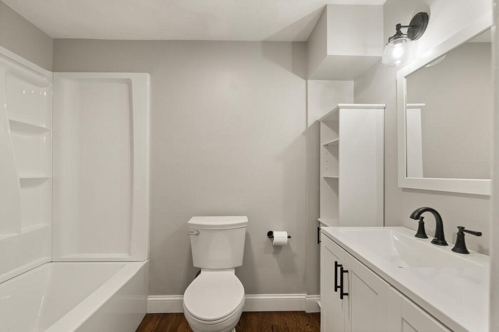 14 Middle Street Wakefield, MA 01880 - Photo 28 of 34 a bathroom with a toilet a sink a mirror and vanity