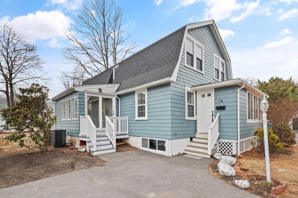 14 Middle Street Wakefield, MA 01880 - Photo 4 of 34 a front view of a house with a garage