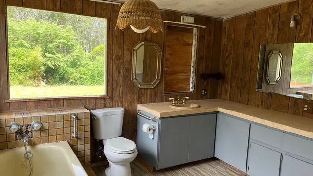 a bathroom with a toilet sink and mirror