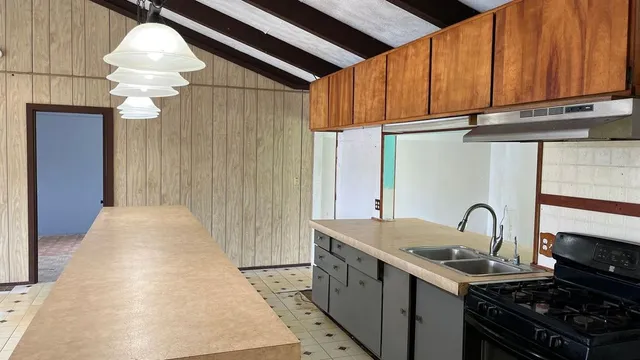 a kitchen with a sink and cabinets