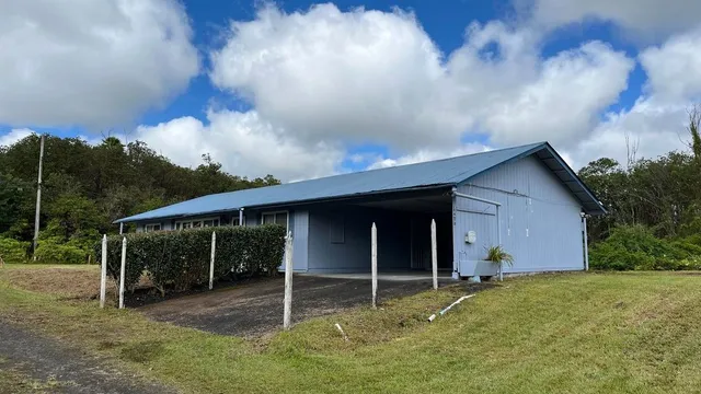 a backyard of a house with table and chairs
