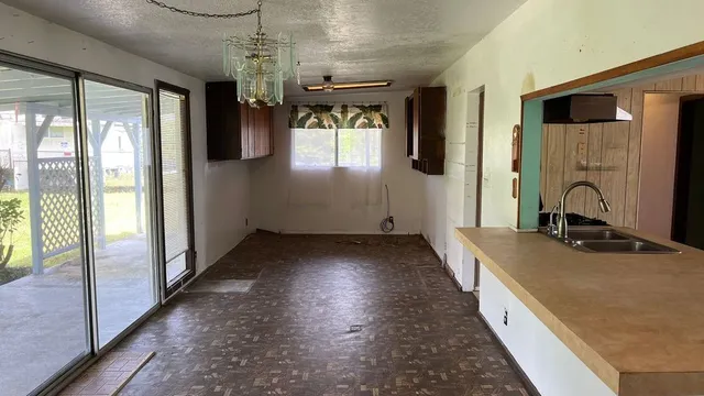 a bathroom with a granite countertop sink a large mirror and a bathtub