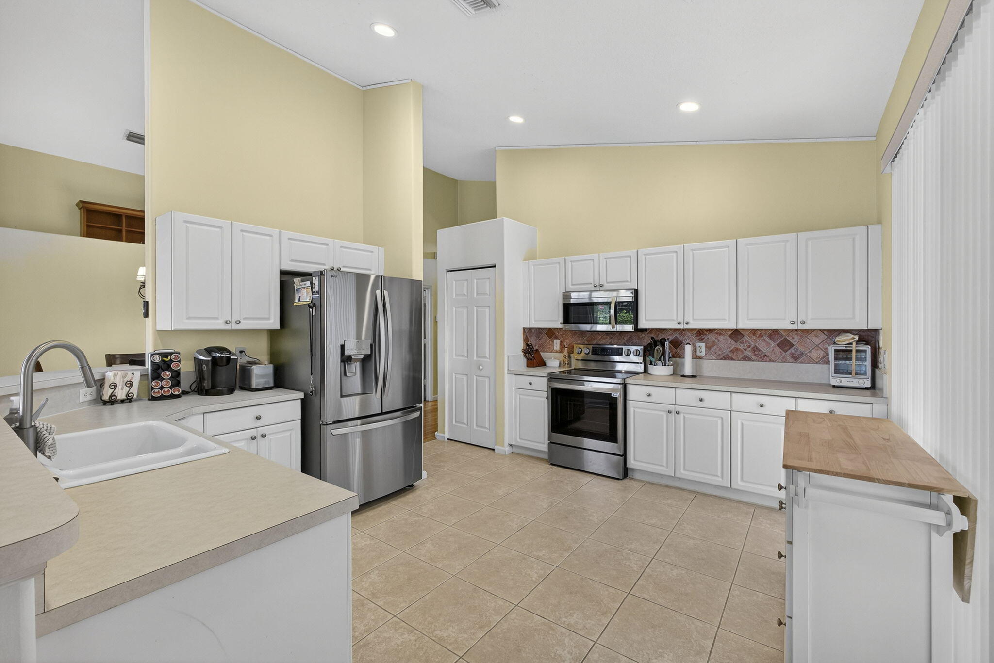 11061 Laurel Walk Road Wellington, FL 33449 - Photo 16 of 67 a kitchen with a sink stainless steel appliances and cabinets