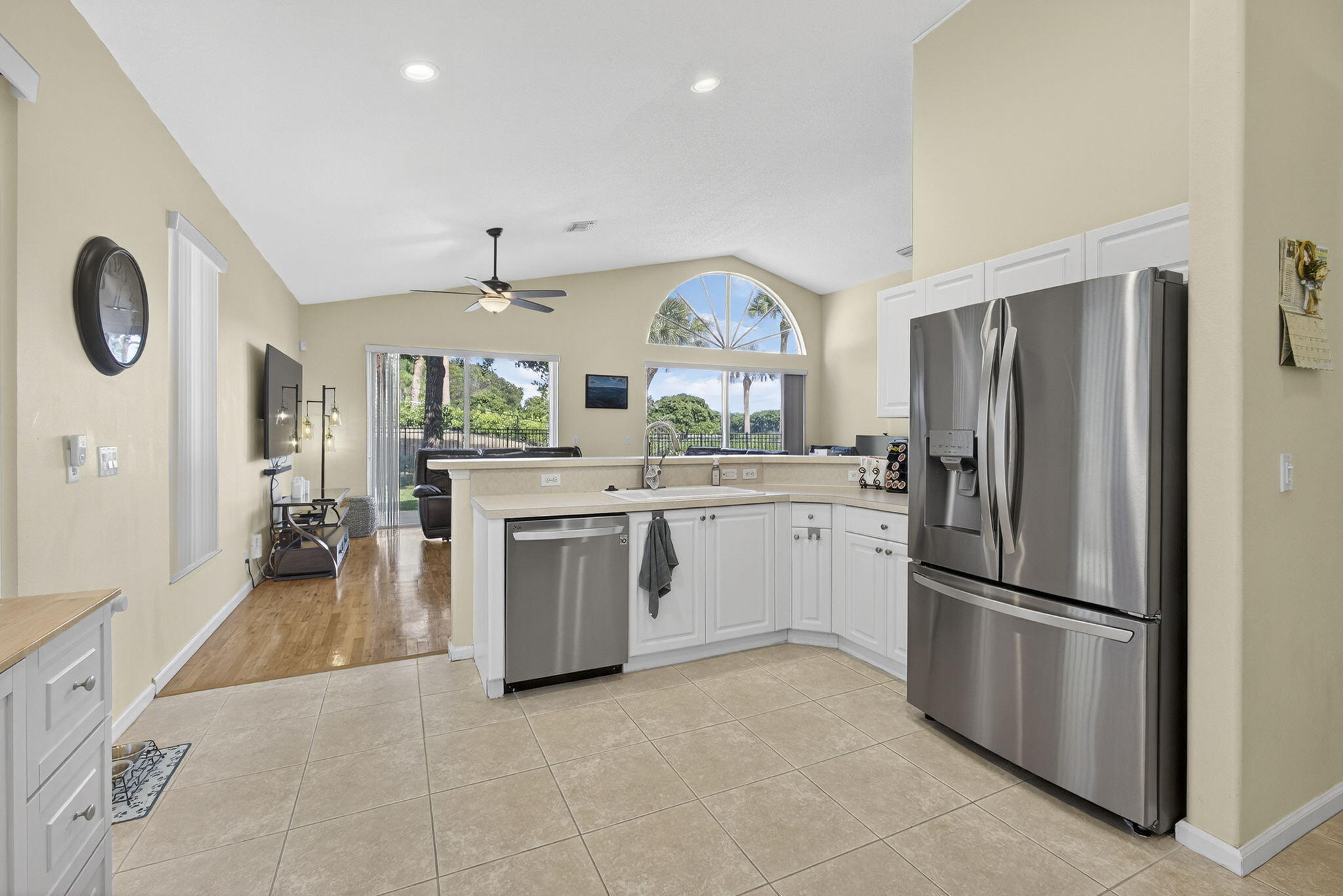 11061 Laurel Walk Road Wellington, FL 33449 - Photo 17 of 67 a kitchen with stainless steel appliances a refrigerator sink and stove