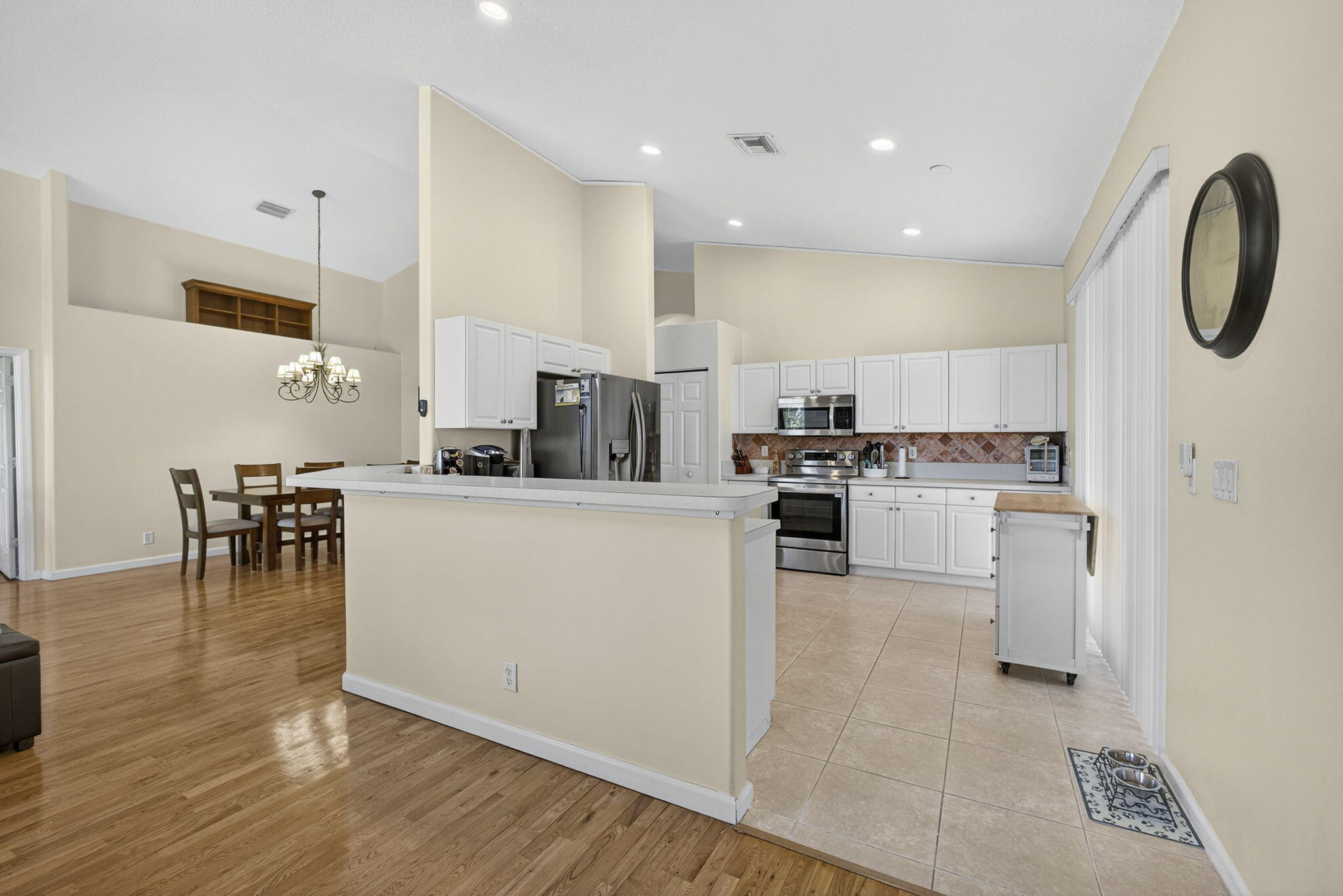 11061 Laurel Walk Road Wellington, FL 33449 - Photo 20 of 67 a kitchen with white cabinets and stainless steel appliances
