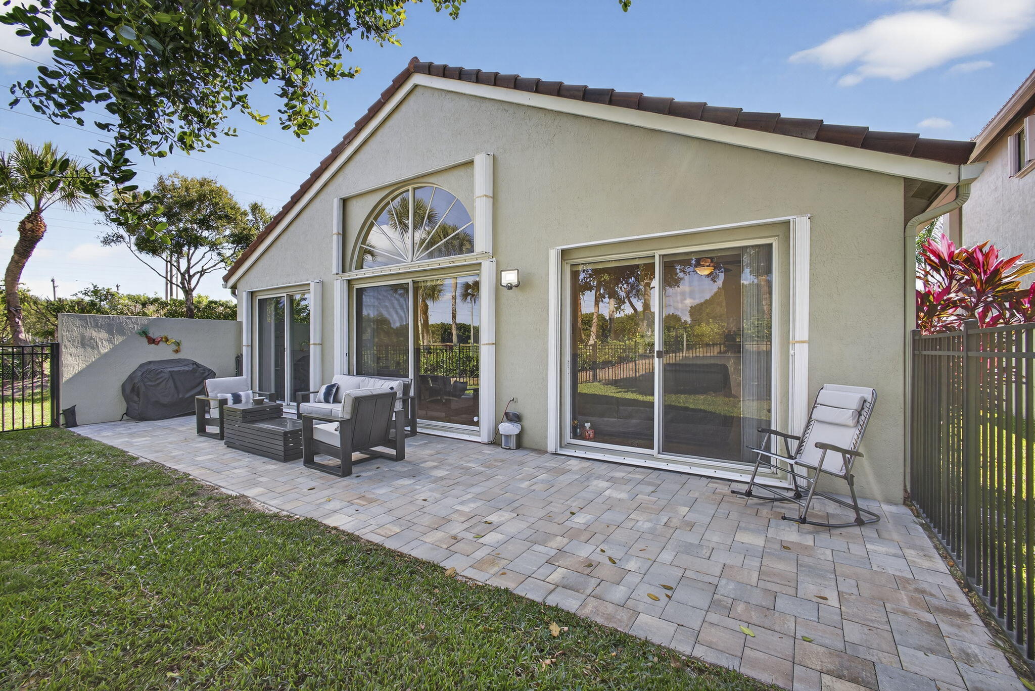 11061 Laurel Walk Road Wellington, FL 33449 - Photo 34 of 67 a view of a house with backyard sitting area and garden