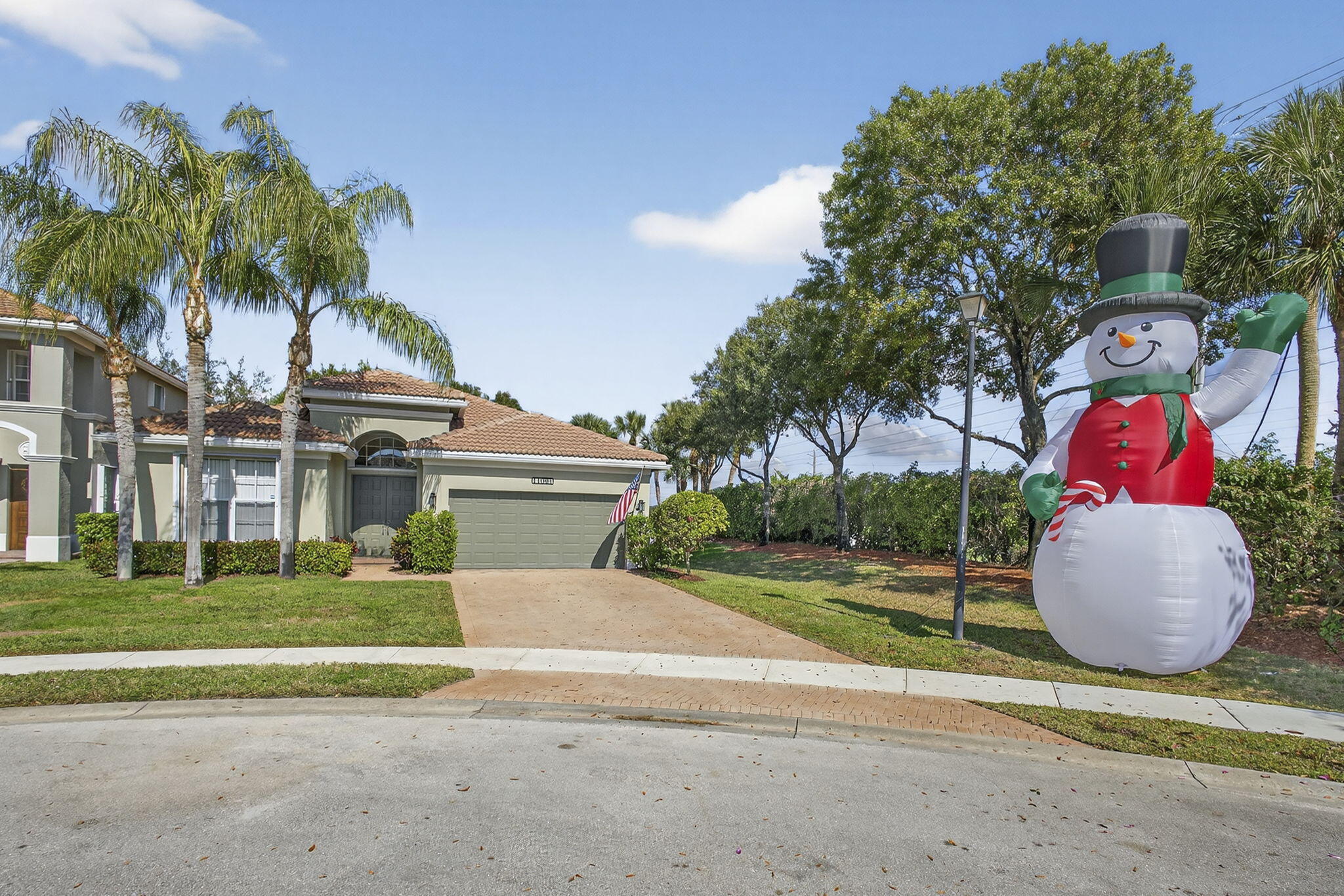 11061 Laurel Walk Road Wellington, FL 33449 - Photo 5 of 67 a view of a house with a yard and palm trees