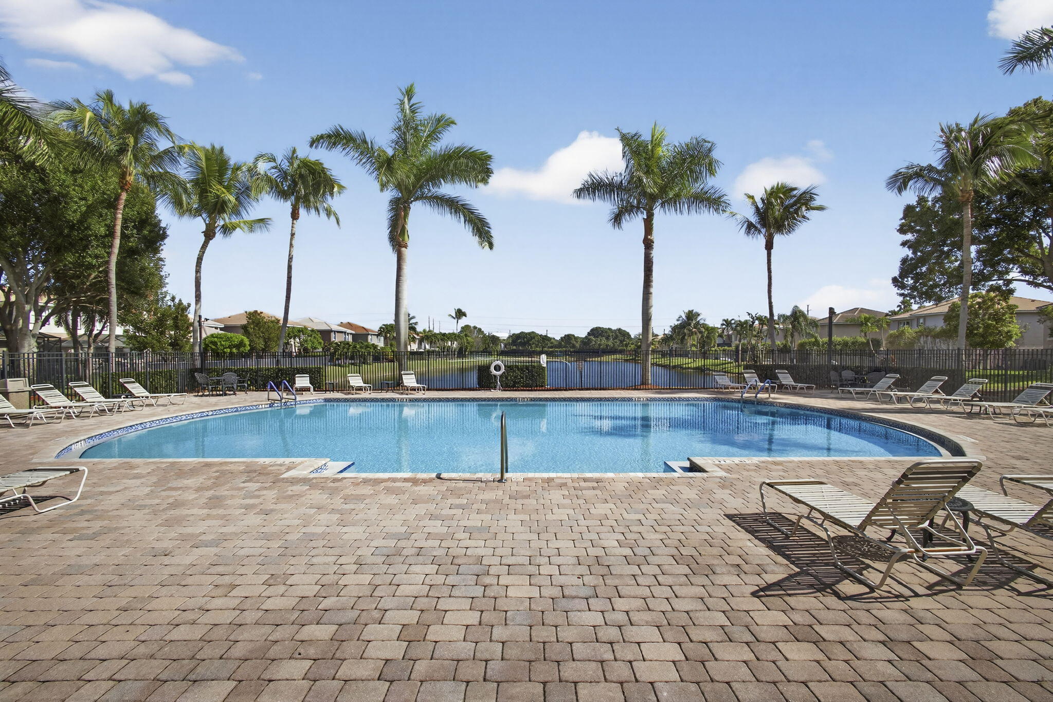 11061 Laurel Walk Road Wellington, FL 33449 - Photo 54 of 67 a view of a swimming pool with a lounge chair