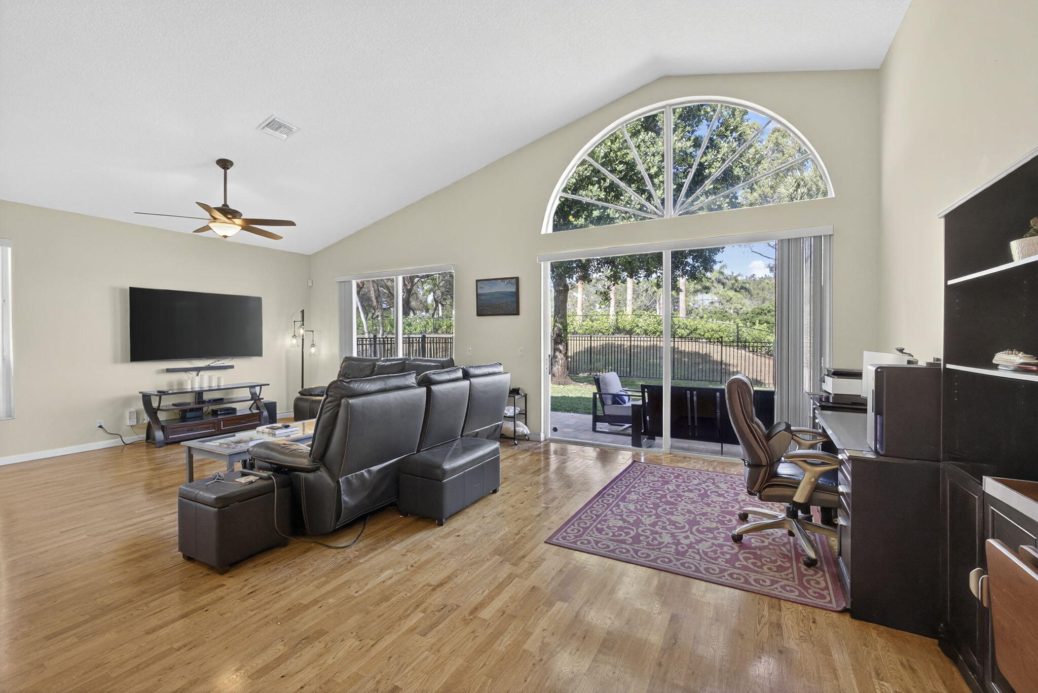 11061 Laurel Walk Road Wellington, FL 33449 - Photo 9 of 67 a living room with furniture a flat screen tv and a floor to ceiling window