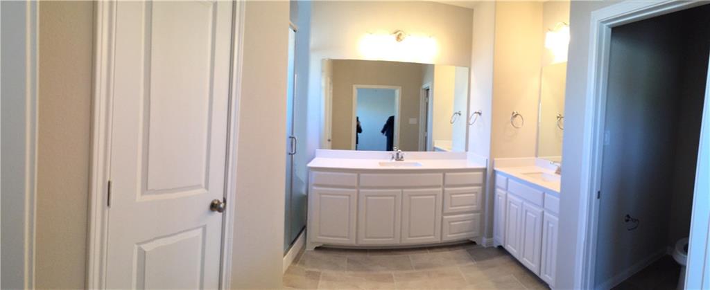 1017 Water Street Carrollton, TX 75007 - Photo 12 of 21 a bathroom with a sink and a mirror
