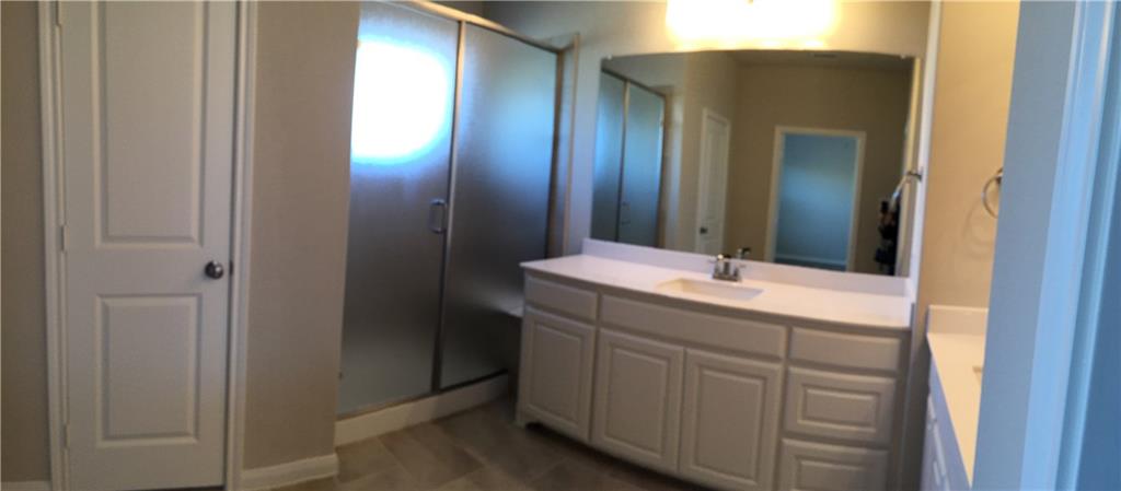 1017 Water Street Carrollton, TX 75007 - Photo 13 of 21 a bathroom with a double vanity sink and a mirror
