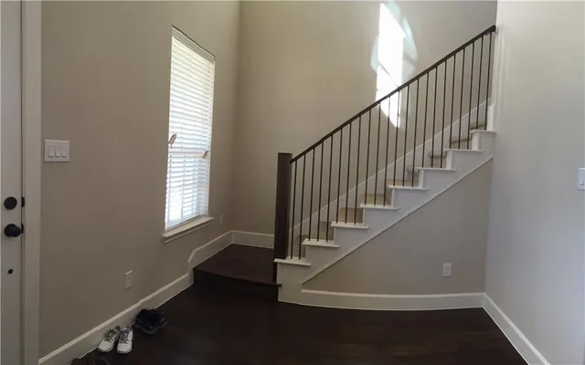 a view of entryway and hall with wooden floor