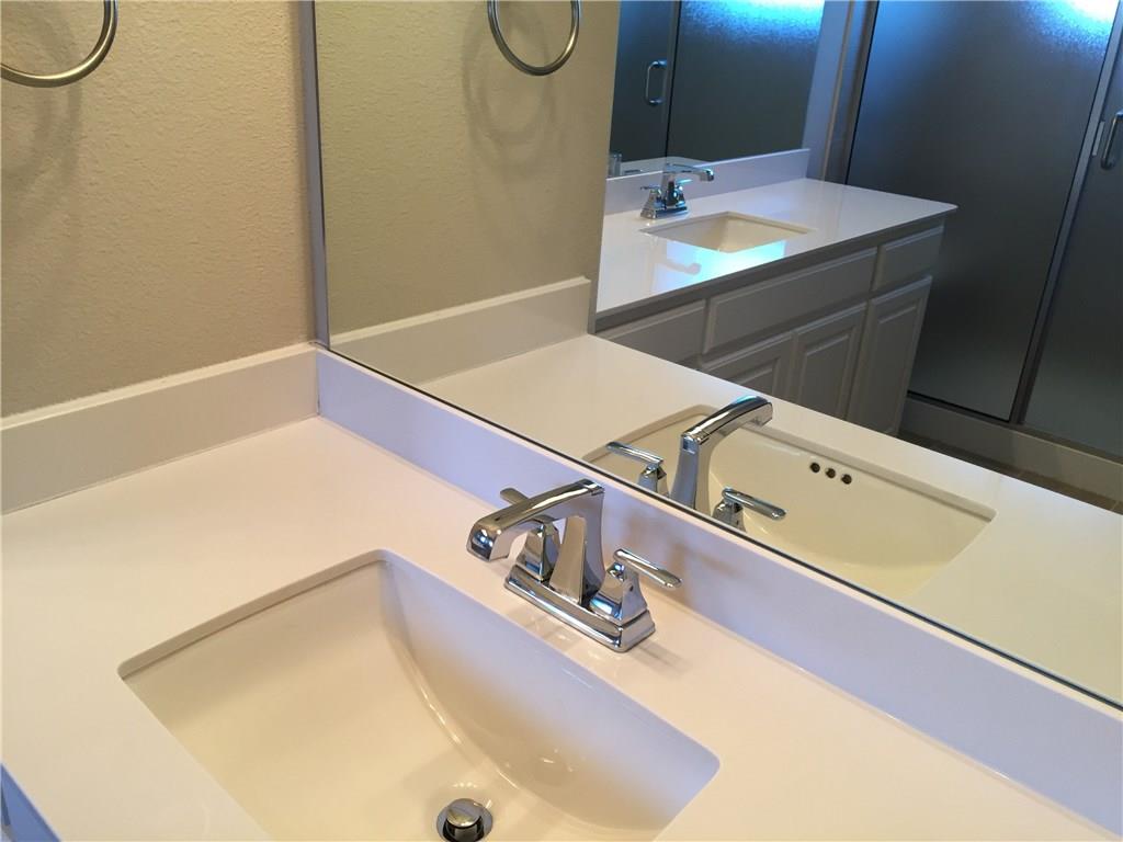 1017 Water Street Carrollton, TX 75007 - Photo 18 of 21 a bathroom with a sink and a mirror