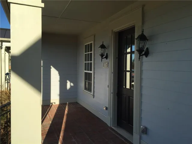 a view of a hallway with a glass door and shower