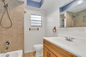 a white bath tub sitting next to a white wall