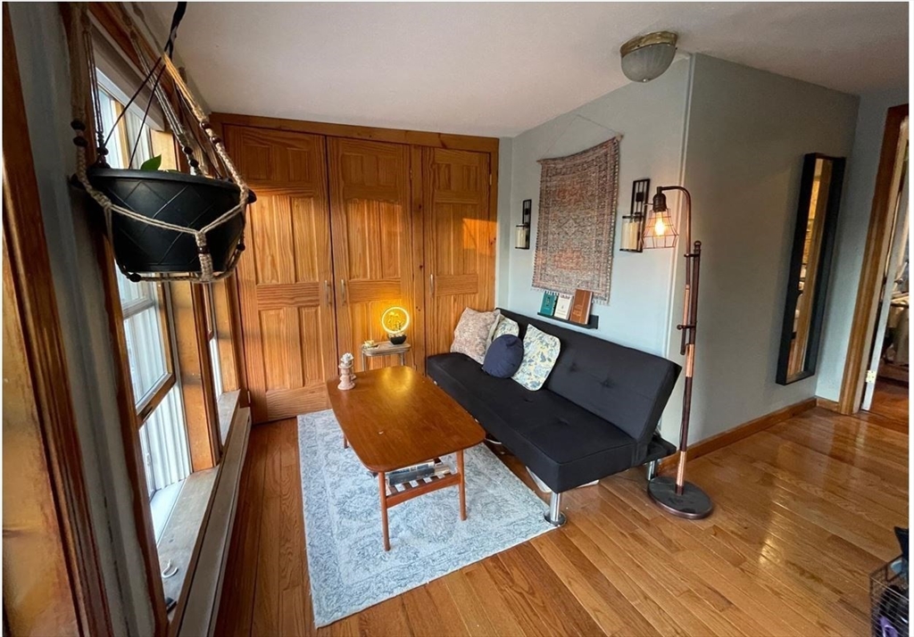 1672 Beacon Street, Unit 3A Brookline, MA 02445 - Photo 3 of 5 a living room with furniture and a window