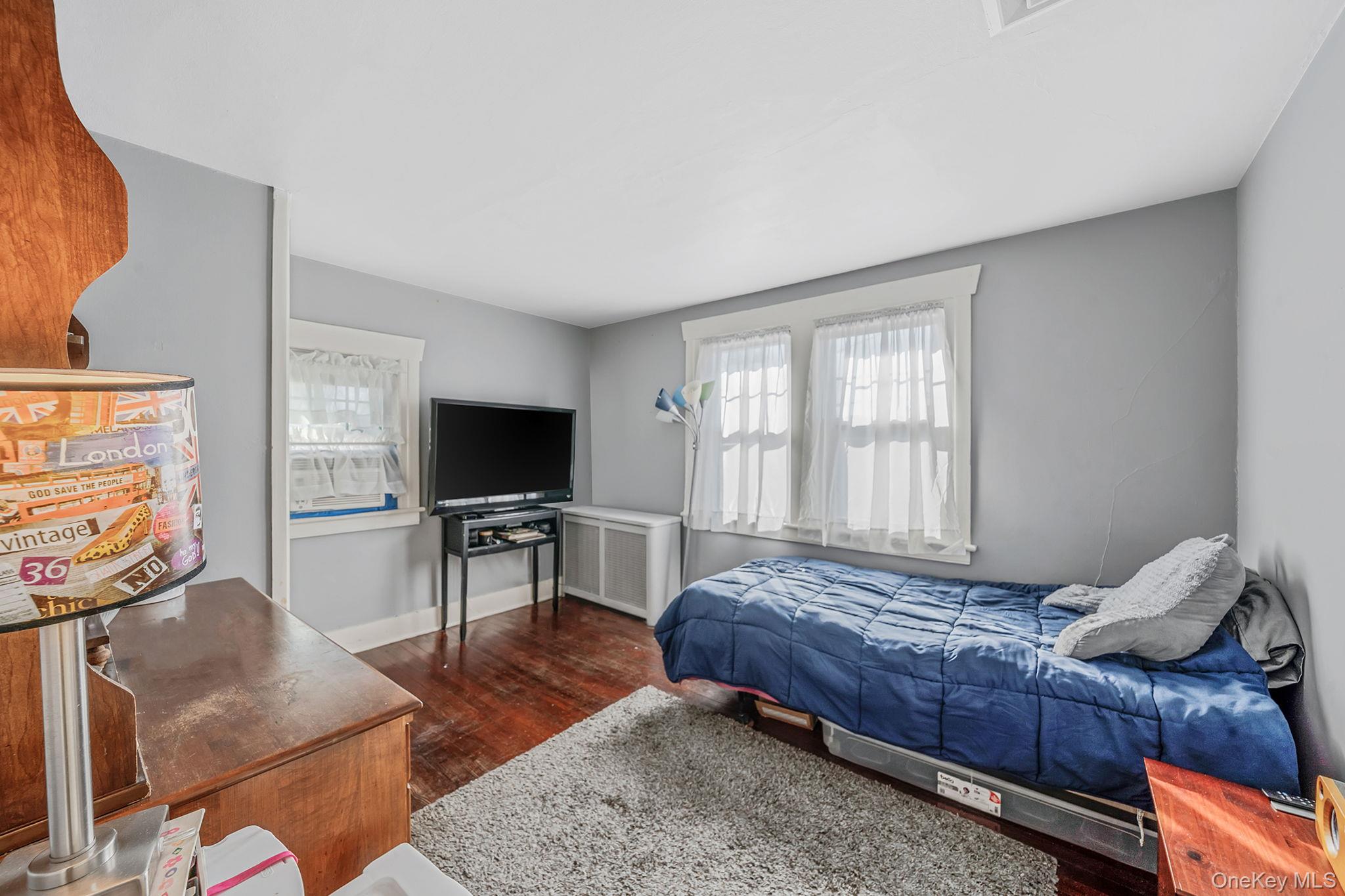 59 Robertson Road Lynbrook, NY 11563 - Photo 16 of 26 a bedroom with a bed and glass door