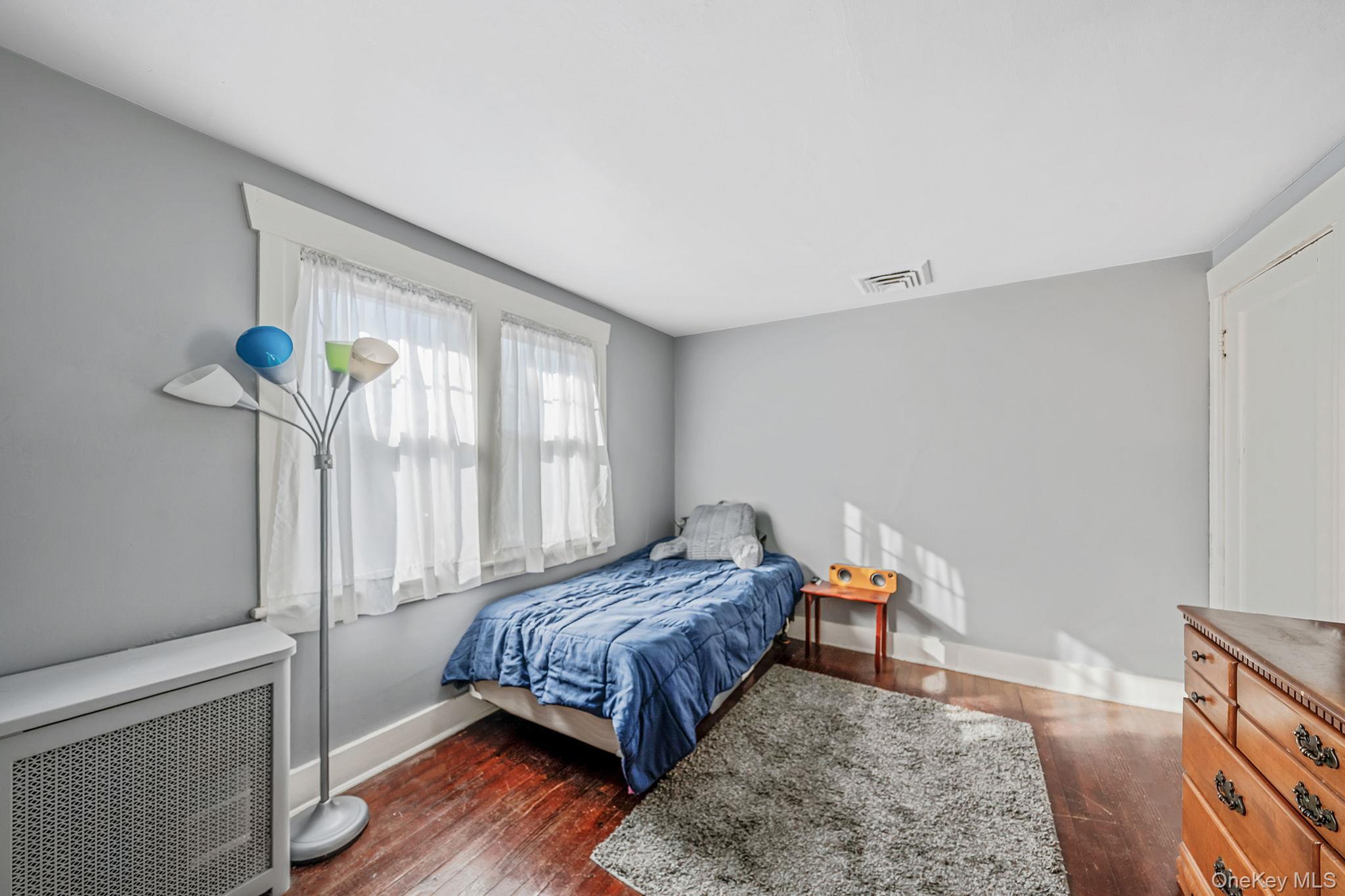 59 Robertson Road Lynbrook, NY 11563 - Photo 17 of 26 a bedroom with a bed and a window