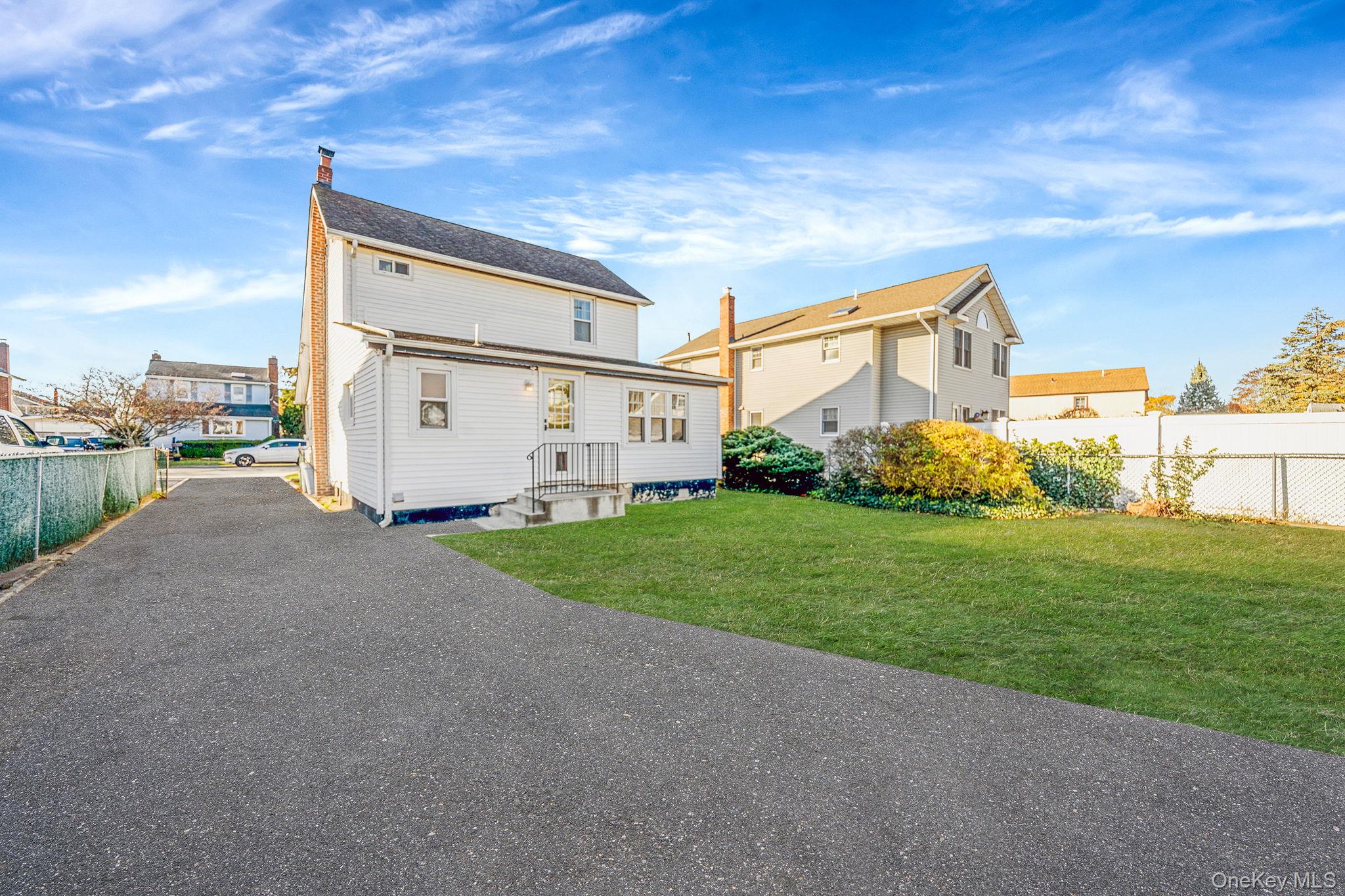 59 Robertson Road Lynbrook, NY 11563 - Photo 20 of 26 a view of a backyard with plants and a garden
