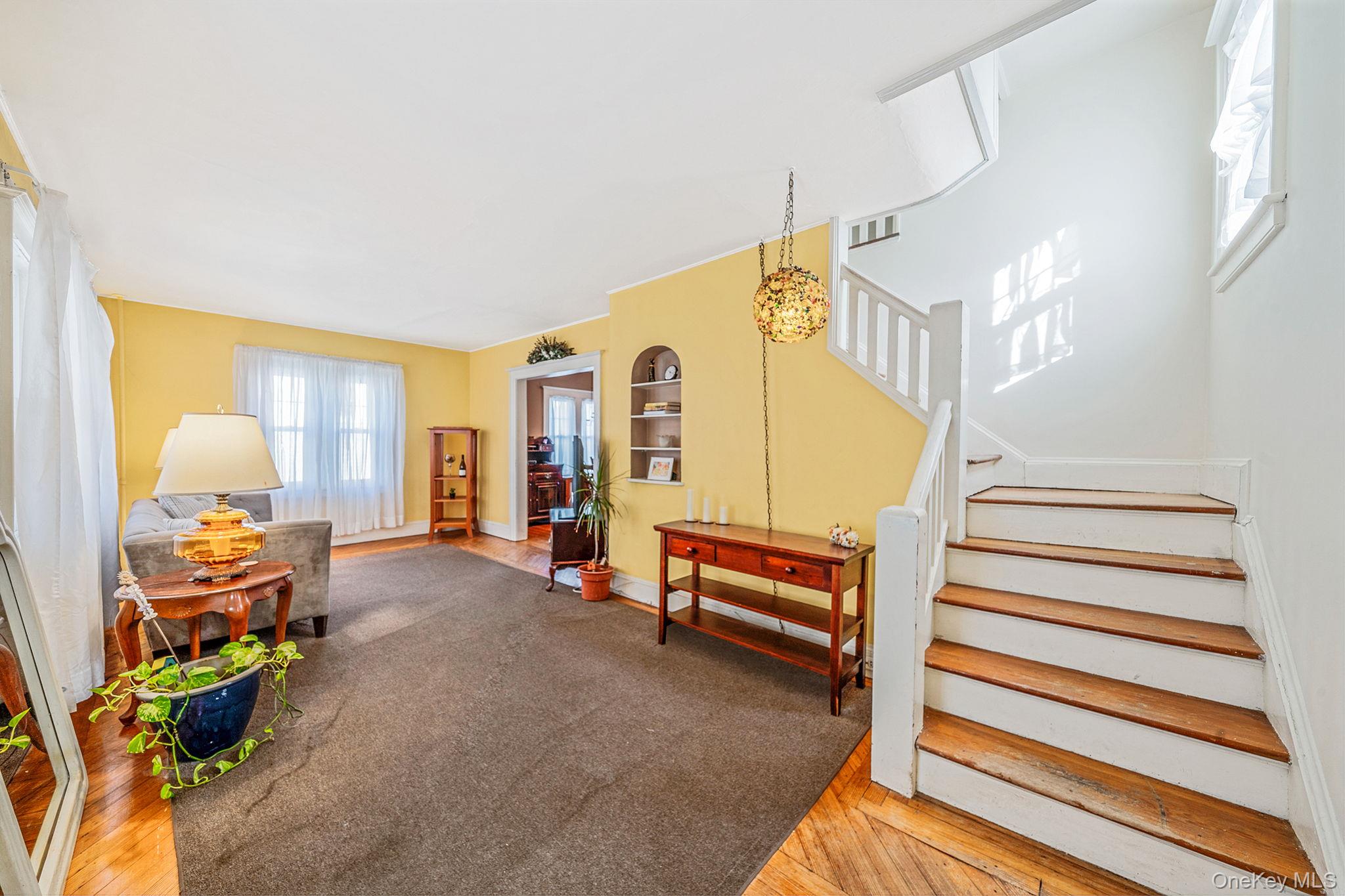 59 Robertson Road Lynbrook, NY 11563 - Photo 4 of 26 a view of a livingroom with furniture and a staircase