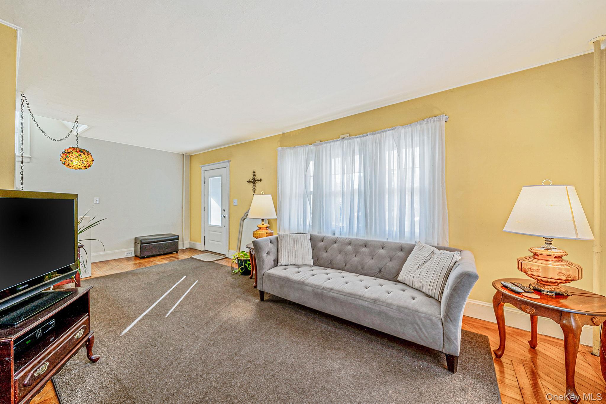 59 Robertson Road Lynbrook, NY 11563 - Photo 5 of 26 a living room with furniture and a flat screen tv