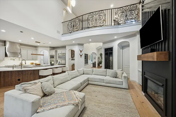 a living room with furniture kitchen view and a fireplace