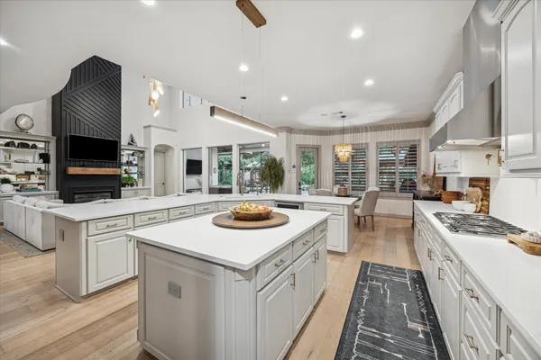 a kitchen with sink stove and refrigerator