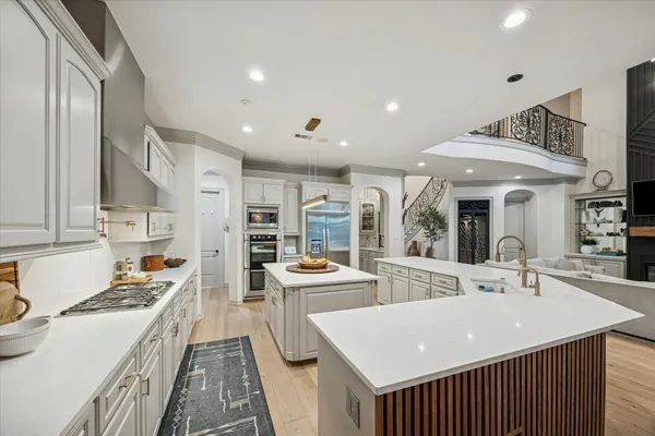 a kitchen with stainless steel appliances a sink stove and cabinets