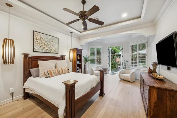 a bedroom with a bed and a flat screen tv