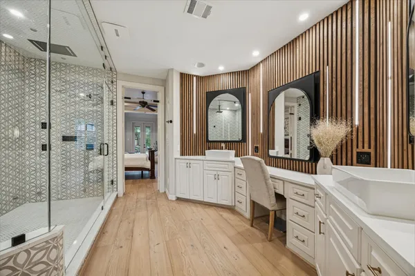 a large bathroom with a double vanity sink a mirror and a bathtub