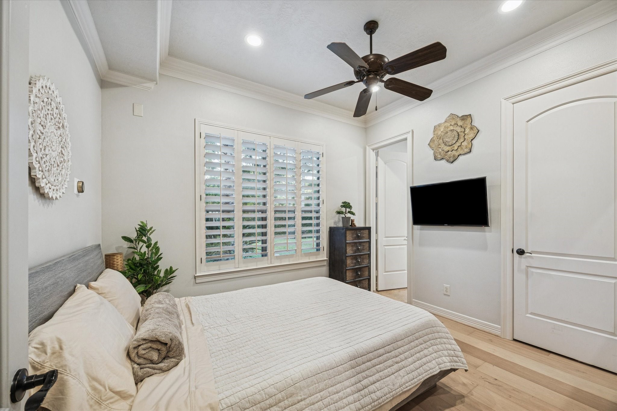 4806 Copper Manor Court Katy, TX 77494 - Photo 22 of 50 a bedroom with a bed a window and a flat screen tv