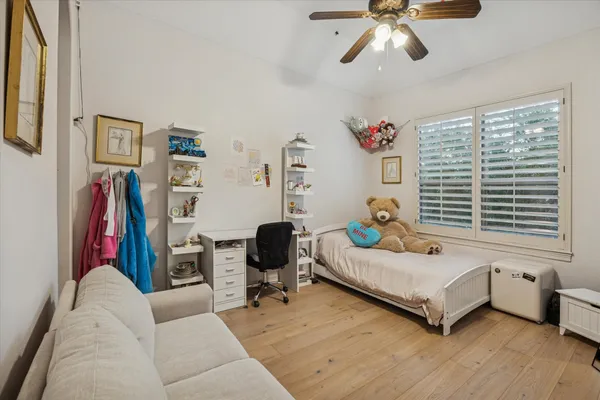 a bedroom with furniture and a window