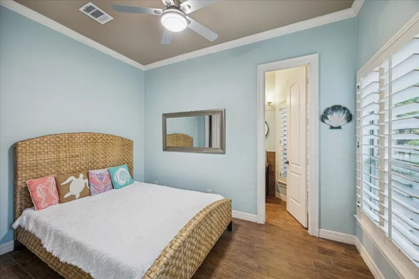 a bedroom with a large bed and a chandelier