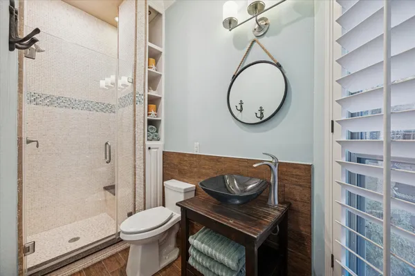 a bathroom with a toilet a sink and a mirror