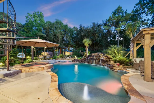 a view of a swimming pool with lounge chairs