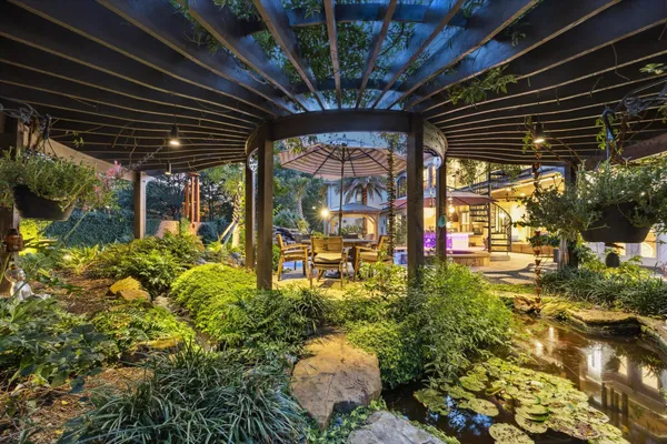 a backyard of a house with a large tree