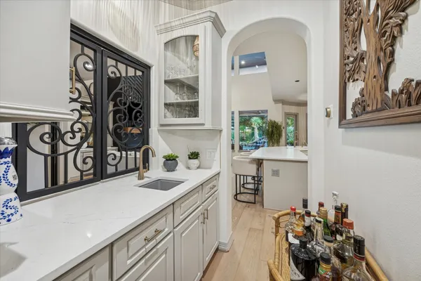 a kitchen with a sink cabinets and window