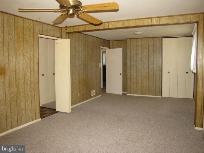 1832 Colmar Road Gwynn Oak, MD 21207 - Photo 3 of 12 a view of a room with a shower and a ceiling fan