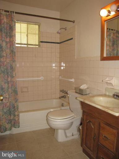 1832 Colmar Road Gwynn Oak, MD 21207 - Photo 6 of 12 a bathroom with a sink a toilet and shower